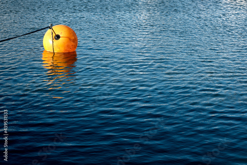 Lonely sea buoy on calm blue water  photo