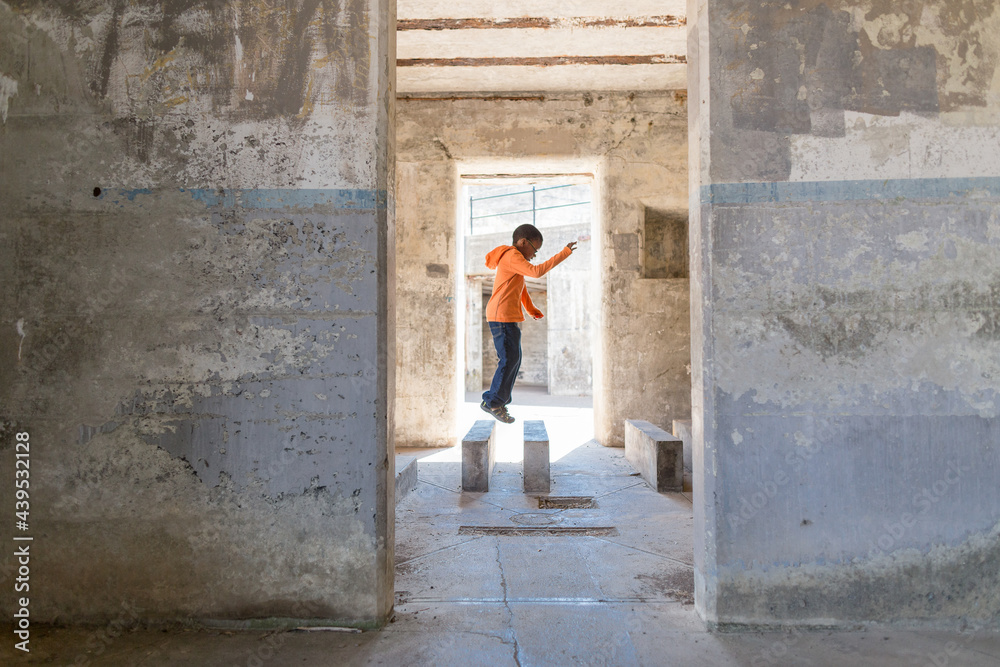 Agile boy hops across concrete blocks Agile boy hops across concrete blocks