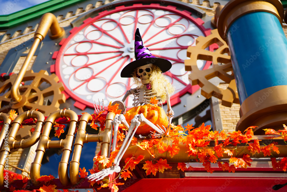 skeleton in a witch's hat in the park. decorations for Halloween celebration. 
