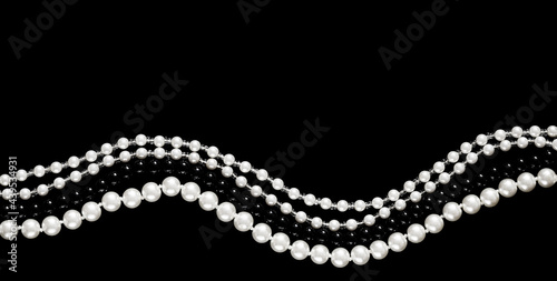 Banner in a dark key with strings of pearl beads in white and black on a black background. An elegant banner with space for text about luxury and the pearl industry.