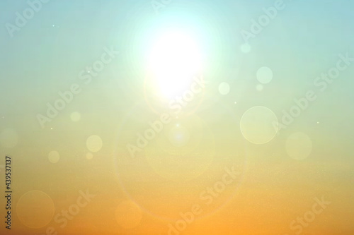 Abstract desert landscape background with yellow sand dust and a glistening sun with blue turquoise sky and bokeh circles. Beautiful texture. Travel and tourism advertisement.
