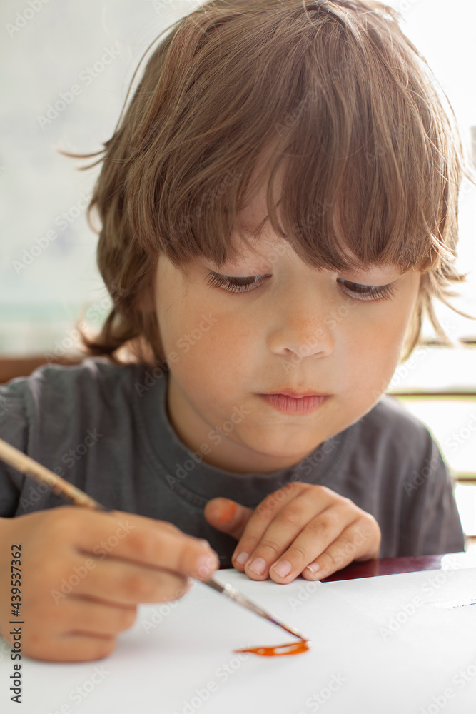 Children draw a picture in home, Boy studying paint with watercolors at school Children draw a picture in home, Boy studying paint with watercolors at school
