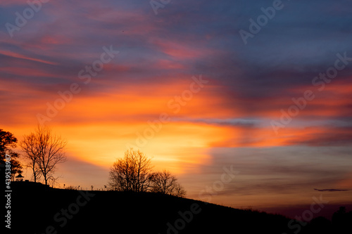 A view of a landscape with a golden evening sky. © wanchai