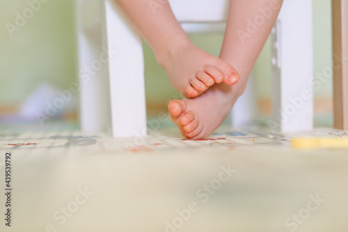 baby feet sitting on a chair photo
