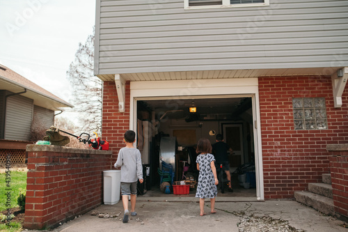 Kids walking into their home's garage.  photo