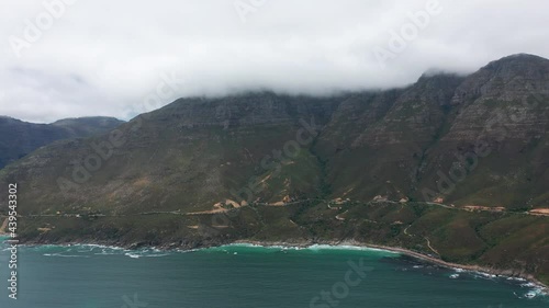 Aerial view. Chapmans Peak Drive near Cape Town, South Africa. Top view of road going through beautiful landscape. Road bending along the ocean.