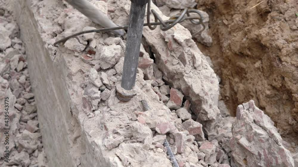Demolition of a jackhammer of a concrete structure at a construction site close-up, top view