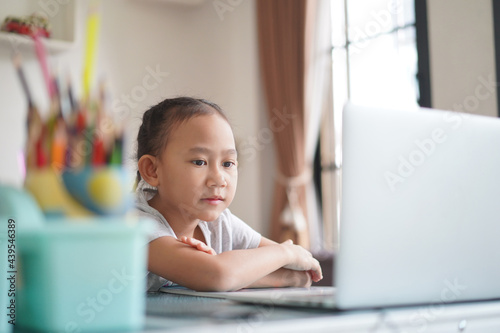 Asian little girl studying homework online lesson, Social distance online education at home idea concept