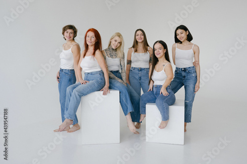 Cheerful diverse smiling women in similar clothes photo
