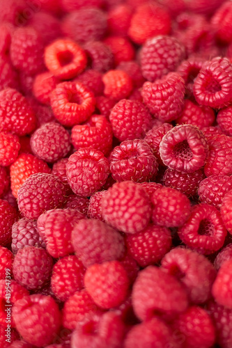Sweet raspberry. Raspberries - raspberry texture background. top view of heap of raspberry as textured background. vertical photo