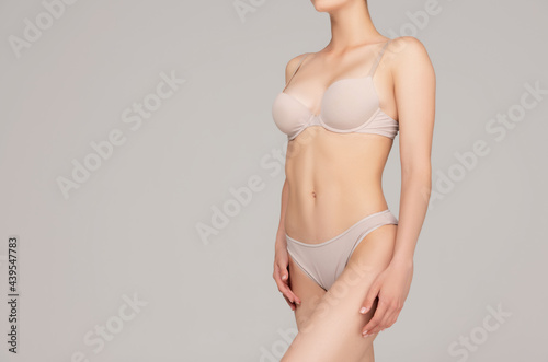 Perfect slim toned young body of the girl or fit woman at studio. The fitness, diet, sports, plastic surgery