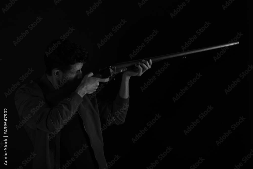 A man with old rifle in black and white
