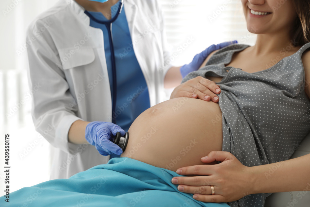 Fototapeta premium Doctor examining woman before giving child birth in maternity hospital, closeup