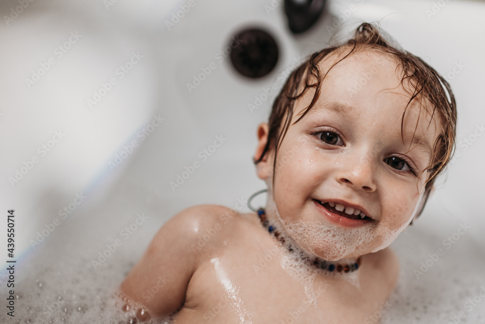 Toddler enjoying a bubble bath at home Toddler enjoying a bubble bath at home