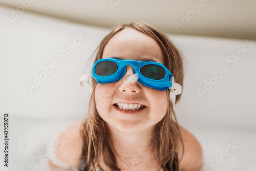 Girl with goggles enjoying bath time photo