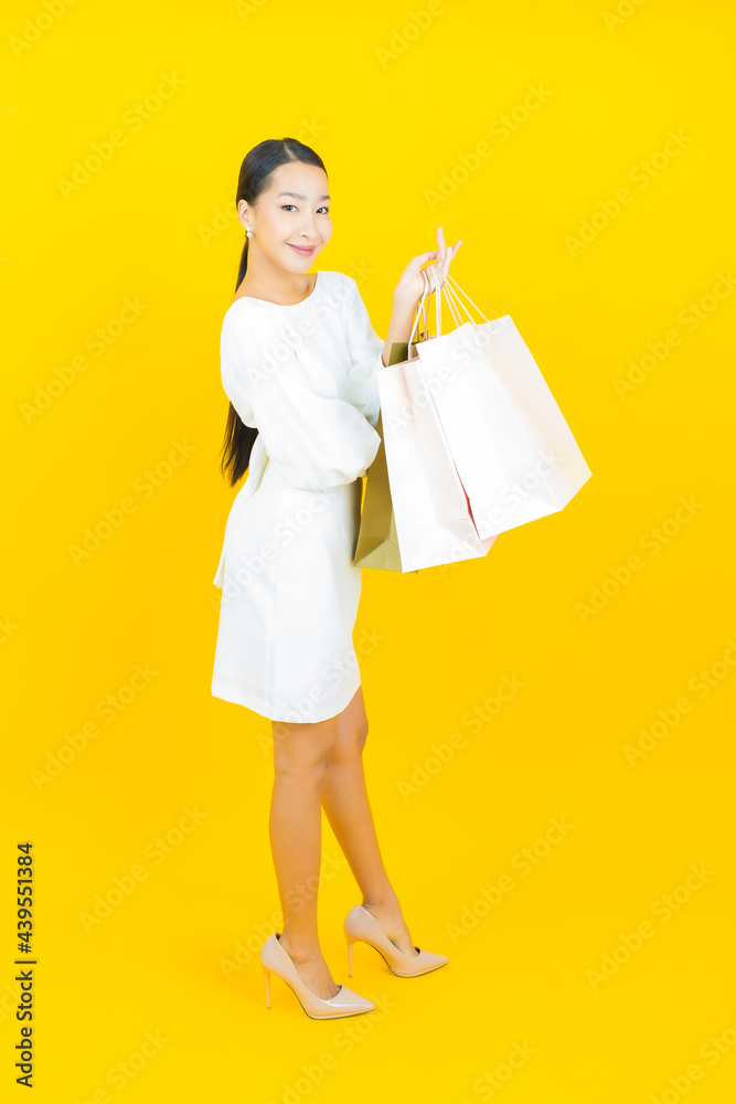 Portrait beautiful young asian woman smile with shopping bag