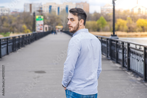 Portrait of a man businessman with a beard in a shirt while walking in the afternoon