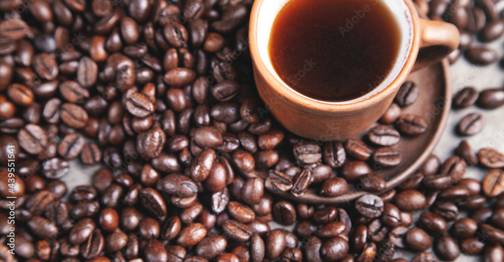 Clay cup of coffee on coffee beans. Clay cup of coffee on coffee beans.