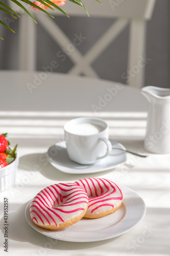 Wallpaper Mural Donuts for breakfast. Beautiful striped donuts on a white plate with a cup of fresh cappuccino on the table. Romantic morning, brunch at home Torontodigital.ca