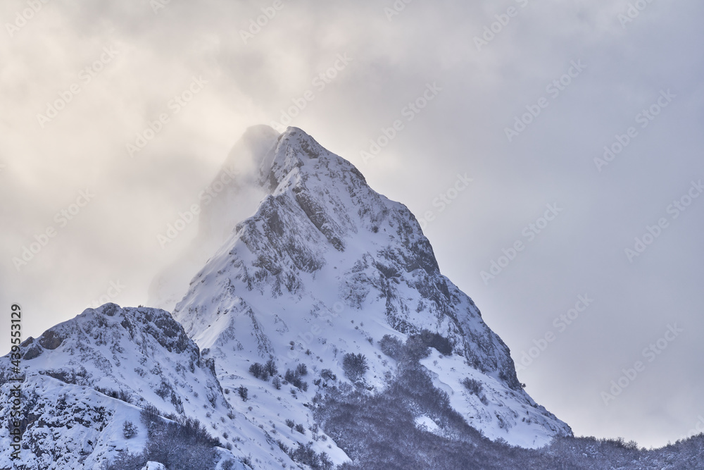Severe landscape with snowy rocky mountain peak Severe landscape with snowy rocky mountain peak