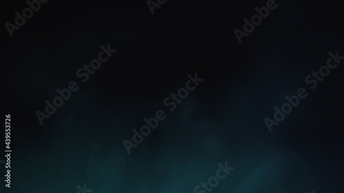 blue powder splashing on black background with copy space