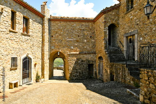 Fototapeta Naklejka Na Ścianę i Meble -  Ruvo del Monte, Italy, June 12, 2021. A narrow street among the old houses of a medieval village in the Basilicata region.