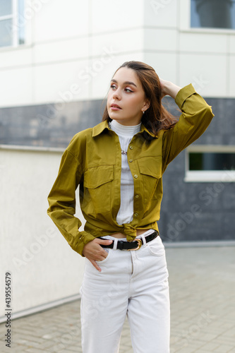 young slim fashion model posing outdoors
