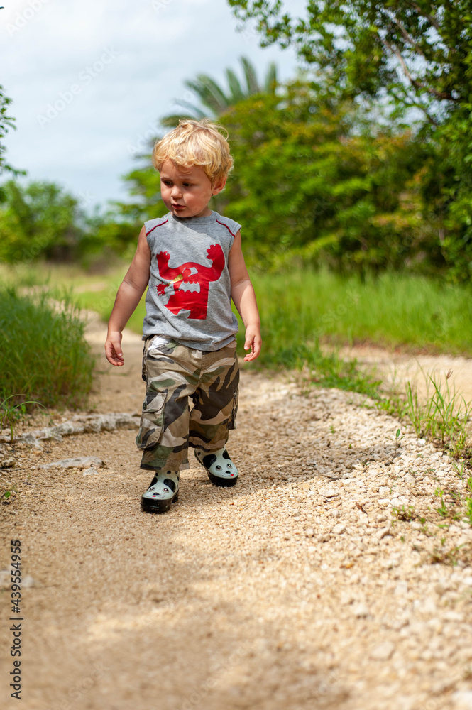 Toddler Walking down Road