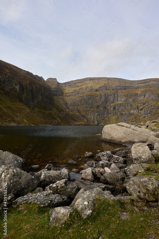 vertical image of a landscape of nature. Mountain with Irish glacial lake. Comeragh Mountains, Waterford, Ireland