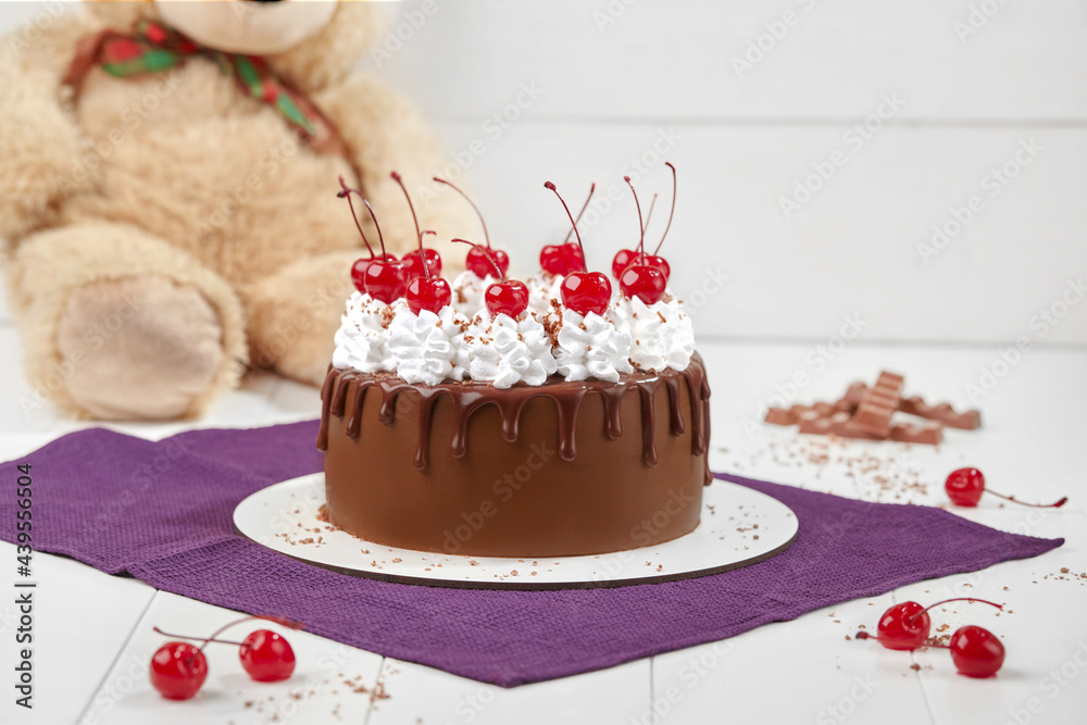 Chocolate sponge cake with whipped cream and maraschino cherries - obrazy, fototapety, plakaty 