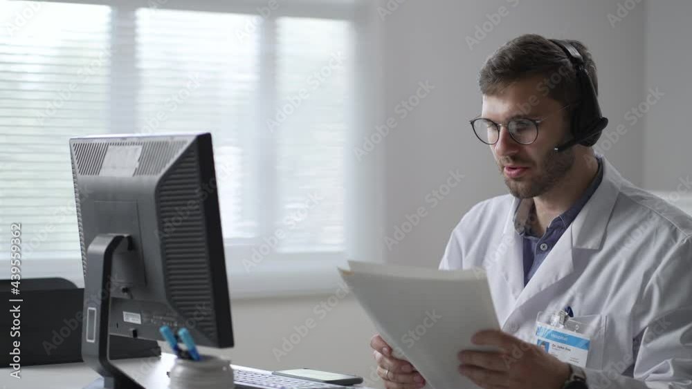 male doctor or nurse with headset and computer working at hospital. Close up of medical operator with headphone consulting patients. Medical man operator working in a medicine call centre male doctor or nurse with headset and computer working at hospital. Close up of medical operator with headphone consulting patients. Medical man operator working in a medicine call centre