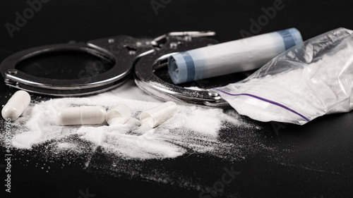 Canvastavla drug punishment, handcuffs and white cocaine powder