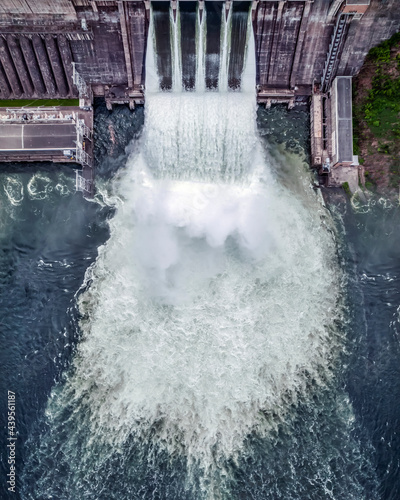 water discharge stream waterfall at the hydroelectric dam. an overflowing reservoir, a huge jet of water, aerial , a drone, the Yenisei river siberia Krasnoyarsk