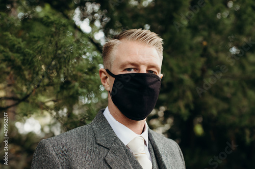 Portrait of Handsome Man in Suit Wearing Face Mask