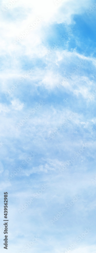 Blue sky background with clouds. Vertical image.Use for cover,wallpaper.