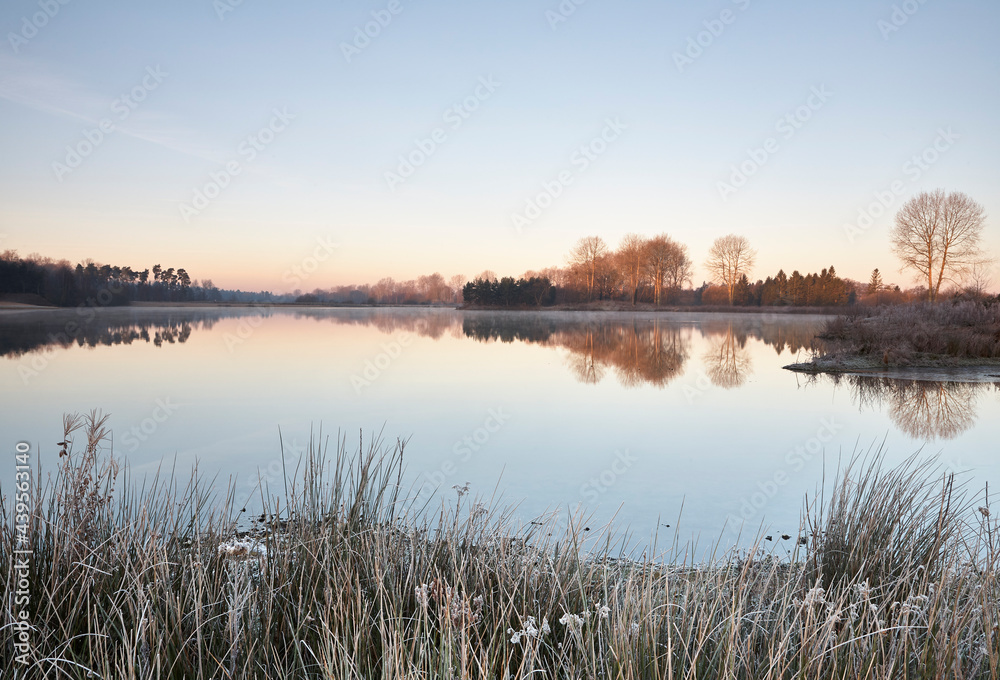 Dawn mist and frost at sunrise. Lynford Lake, Norfolk, UK. Dawn mist and frost at sunrise. Lynford Lake, Norfolk, UK.