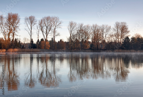 Dawn mist at sunrise. Lynford Lake, Norfolk, UK. photo