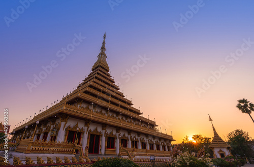 golden ancient pagoda of Phra Mahathat Kaen Nakhon  Wat Nong Wang  temple with twilight sunset sky  Thai traditional religious history travel attraction in Khon Kaen  Thailand