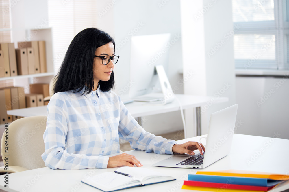 Portrait of a business woman at workplace in office