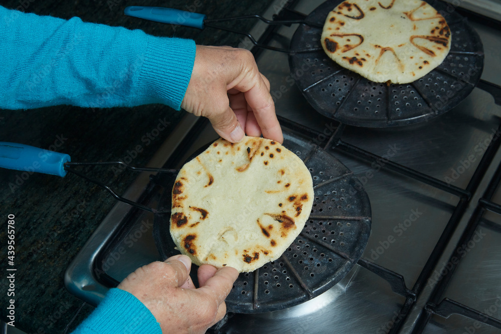Roasting corn arepas on a grill. Typical food of Colombia Stock Photo ...