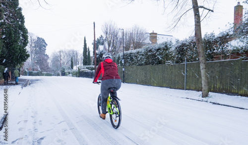 Girl riding a yellow mountain bike on the snow