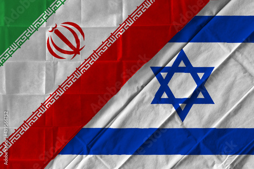 Concept of the relationship between Iran and Israel  with two flags over each other