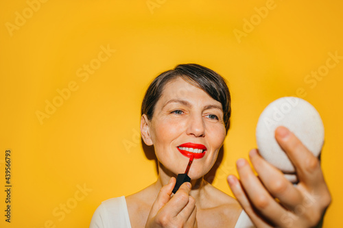 Woman Putting Red Lipstick 