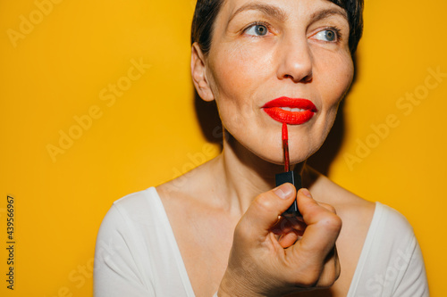 Woman Putting Red Lipstick 