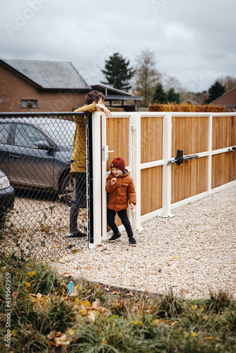 Son trying to keep dad out of the garden  photo