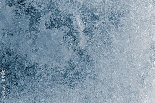 Crunchy ice texture crystal blue tone background. The textured cold frosty surface of the ice.