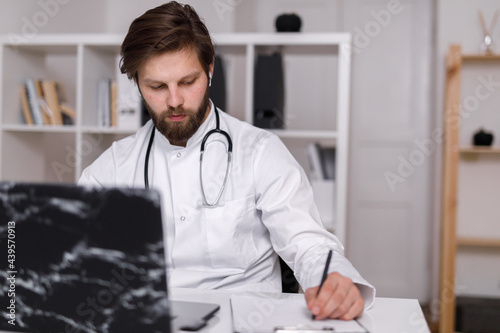 Doctor filling forms about client  photo