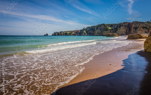 Fototapeta Naklejka Na Ścianę i Meble -  Praia da Dona Ana Beach, sandy beach with clear blue water between cliffs on a sunny day, no people, Lagos, Algarve, Portugal