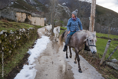 person riding horse tackless 