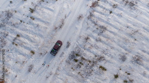 Winter fun: couple riding ski towed  to the car